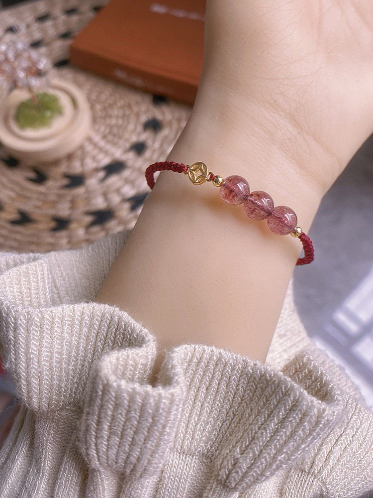 Strawberry quartz bangle bracelet with coin charm for energy balance.