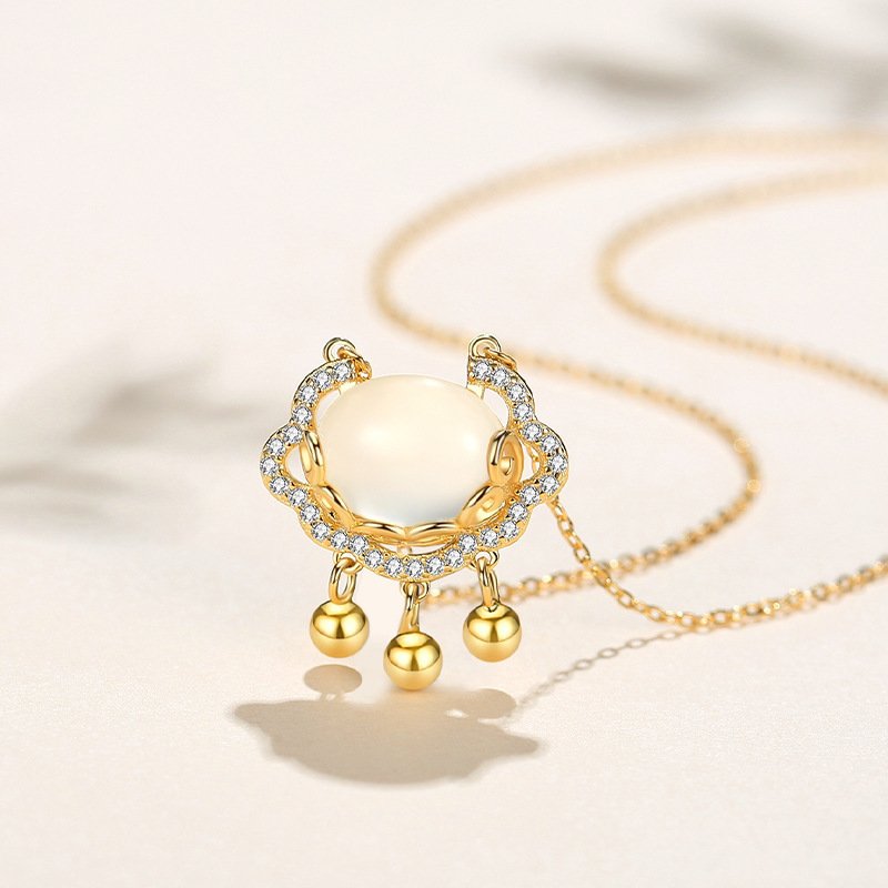 Blue Blazing Serenity Talisman necklace with divine fire charm, small pearl accents.