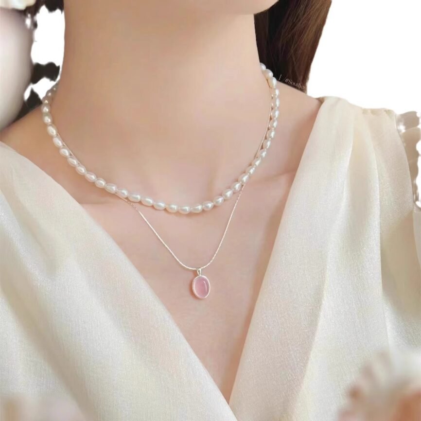 Blazing rose quartz phoenix pendant with intricate details, close-up view.