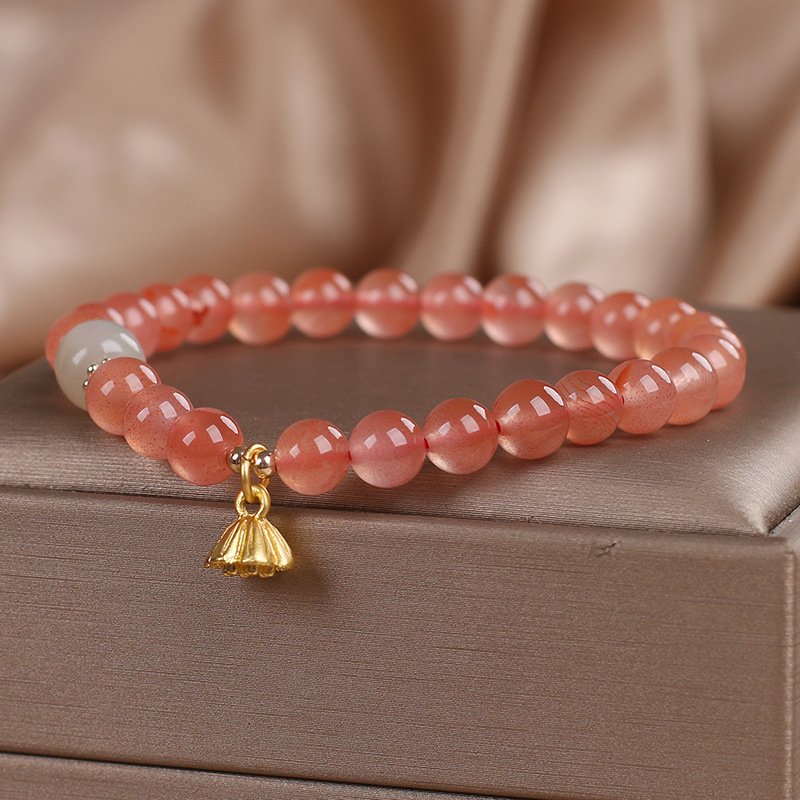 Crimson Lotus Ember bracelet bangle with fiery charm detail.