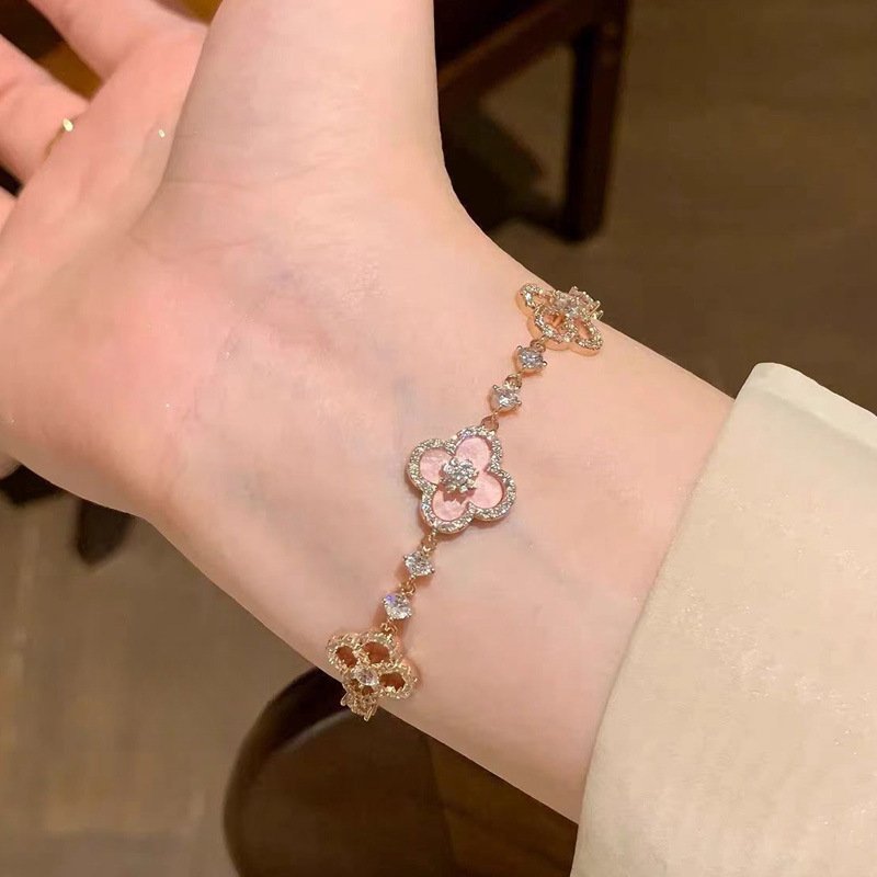 Blue Emberglow Blossom Pact bangle bracelet with radiant charm detail.