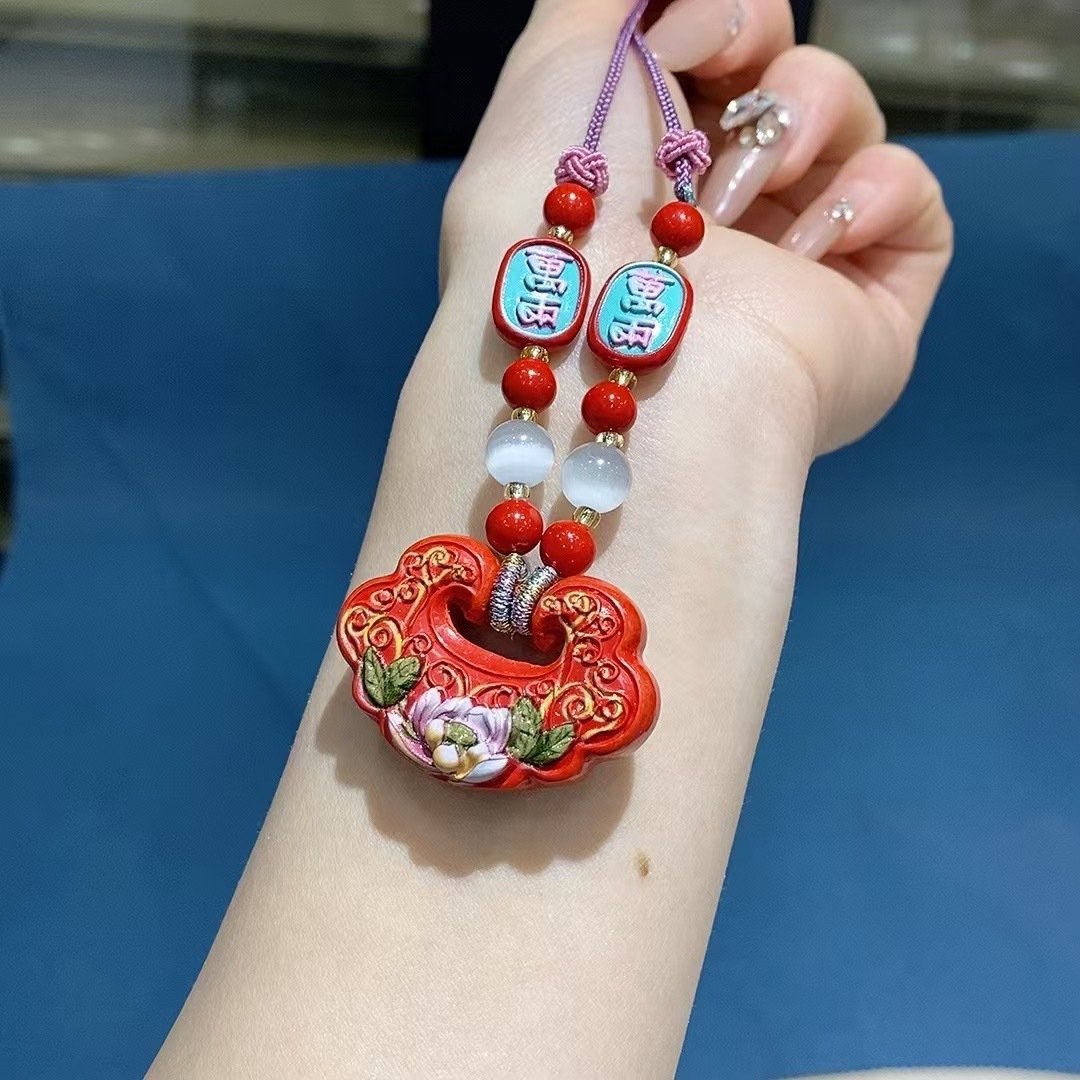 Blue jade necklace with phoenix talisman charm, sacred fire design.