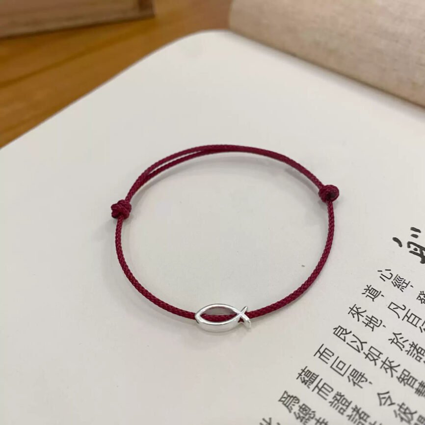 Emberglow red string bracelet with ancient Chinese charm, artisan jewelry.