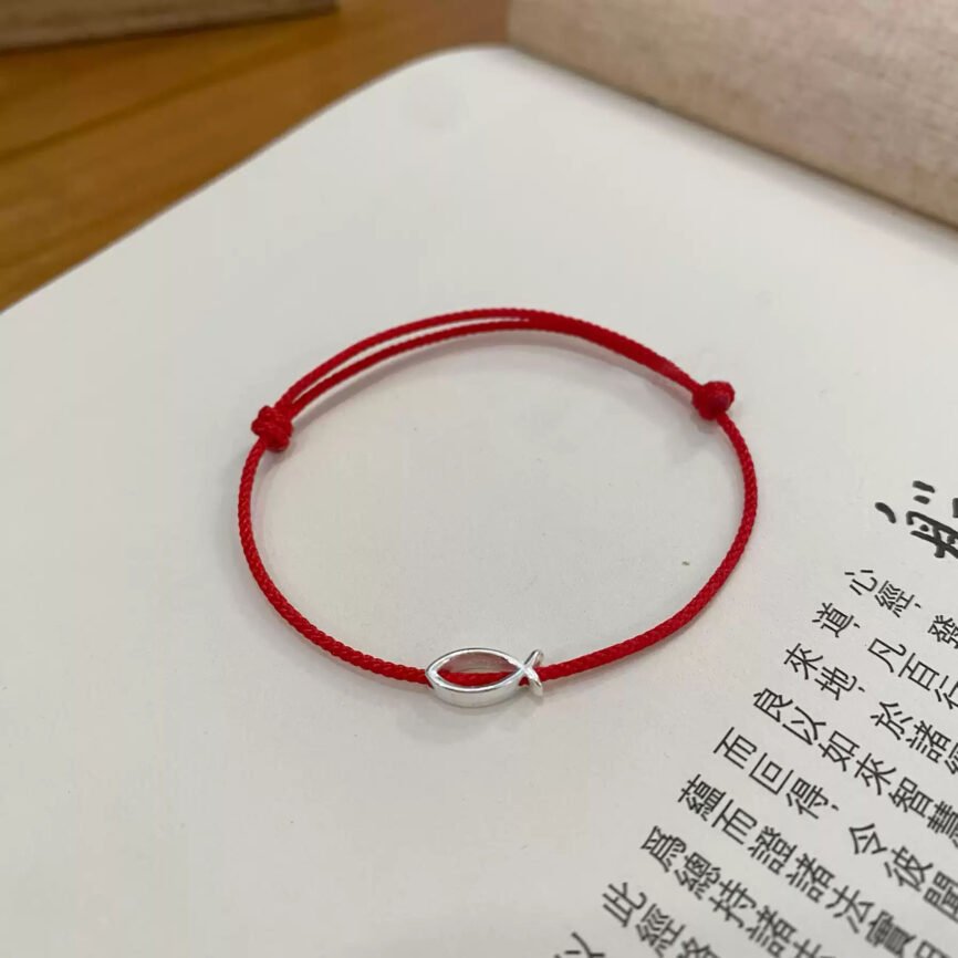Emberglow red string bracelet with ancient Chinese charm, artisan jewelry.