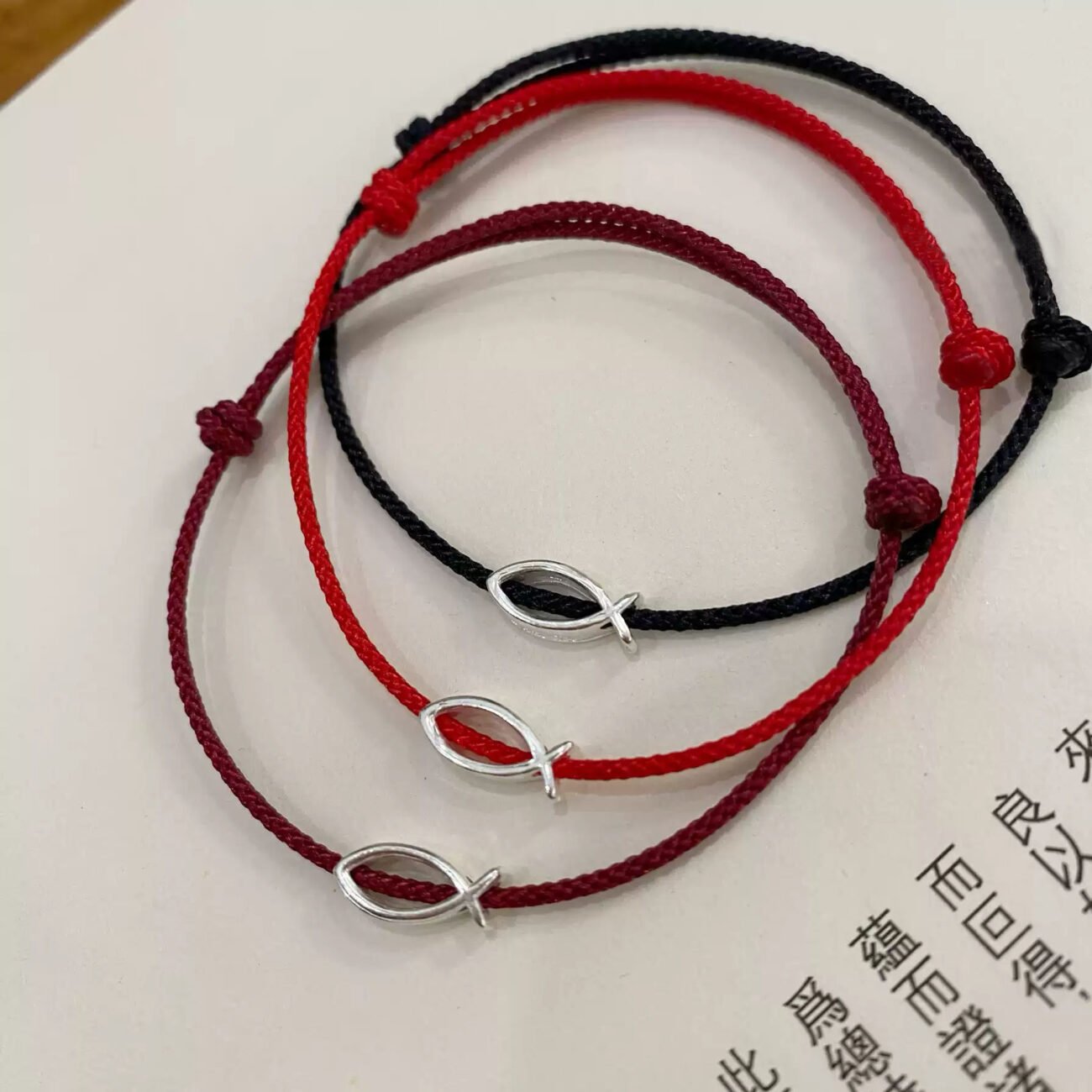 Emberglow red string bracelet with ancient Chinese charm, artisan jewelry.