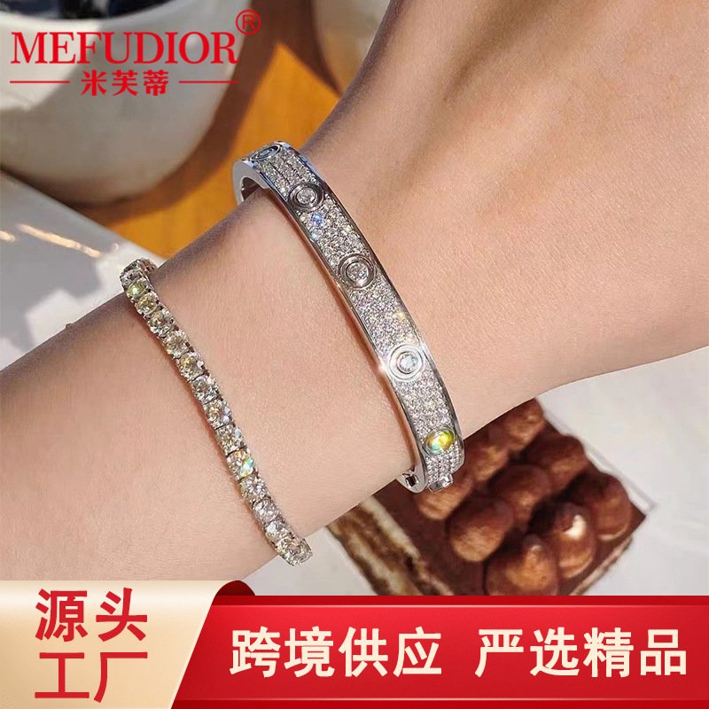 Celestial silver bangle bracelet with a love-themed charm.