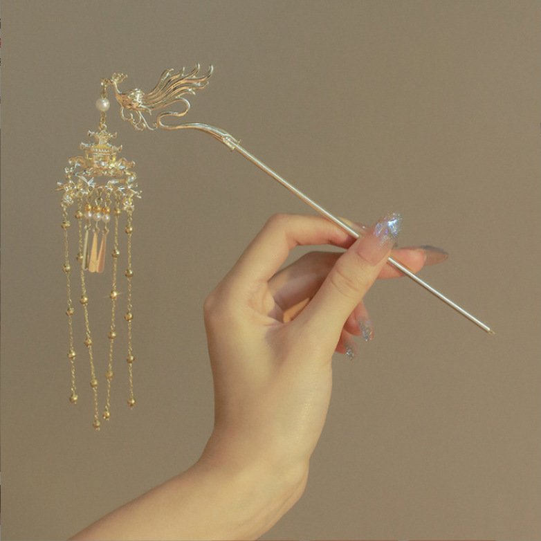 Blue Phoenix Perch Cloudpin hairpin with elegant metal detailing, close-up view.