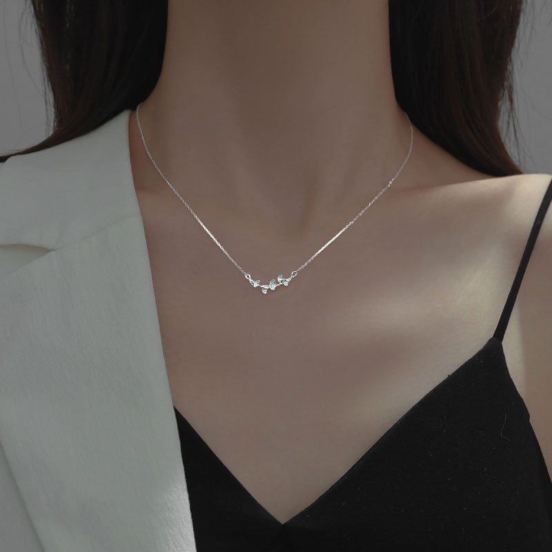Silver leaf charm necklace with flowing metal design for balance and fortune, artisan jewelry.