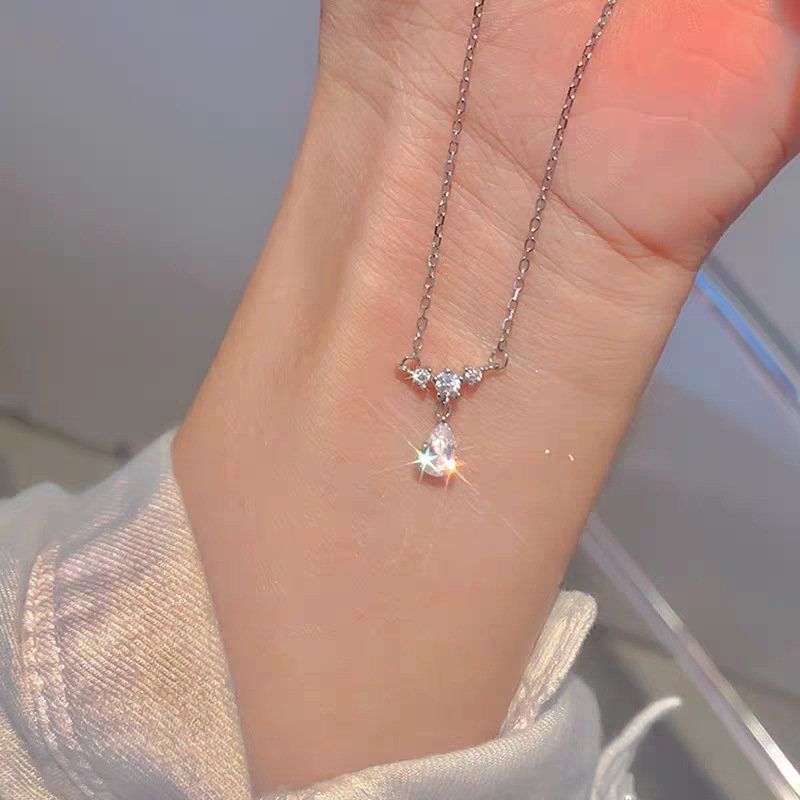 Silver tear pendant lucky charm necklace with celestial metal charm.