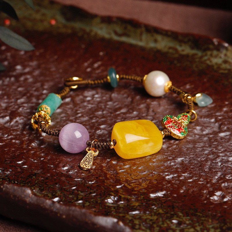 Celestial gold charm bracelet with intricate artisan metal details.
