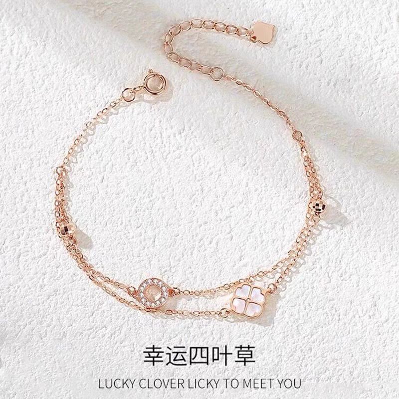 Layered silver bangles with lucky charm detailing for fortune and harmony.