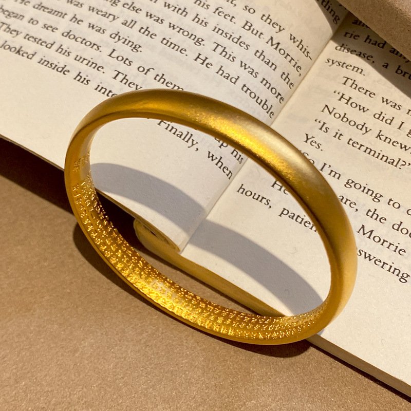 Mystic Gold Essence jade and gold ring, close-up of intricate charm.