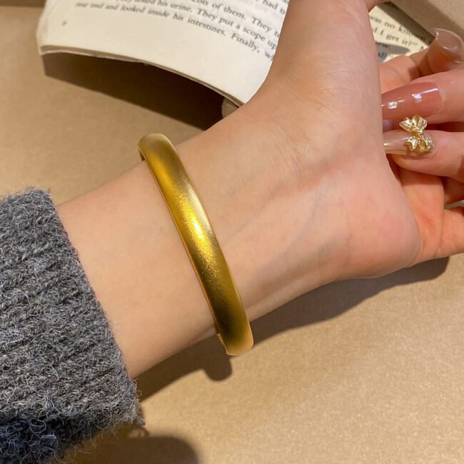 Collection of fashionable gold bangles showcasing versatile bracelet fashion jewelry options