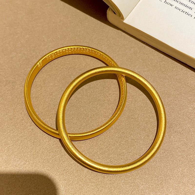 Celestial Flow artisan gold bangle with radiant metal balance.