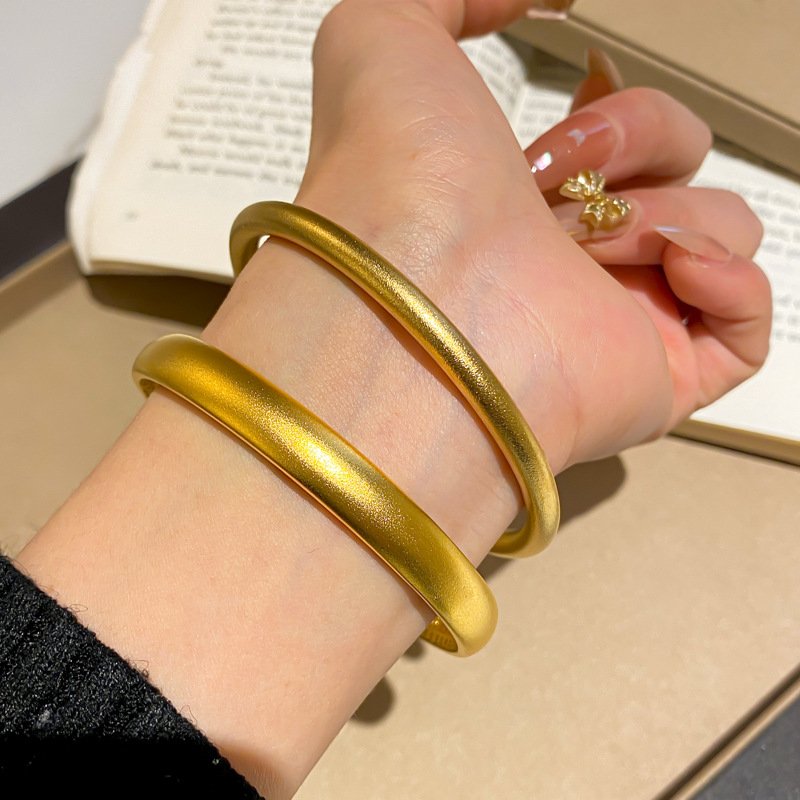 Celestial Flow artisan gold bangle with radiant metal balance.