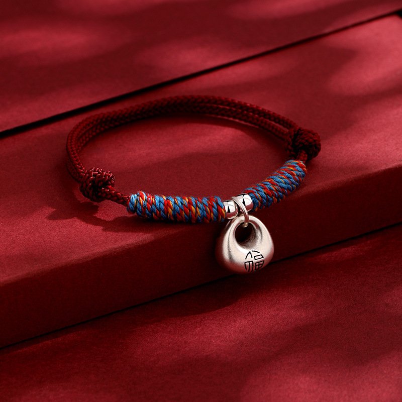 Red string Silverbound Fate Bracelet with metal-forged charm, artisan jewelry.