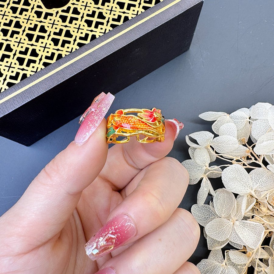 Luminous Scale Goldmoon jadeite ring with intricate metal design, symbolizing wealth and balance.