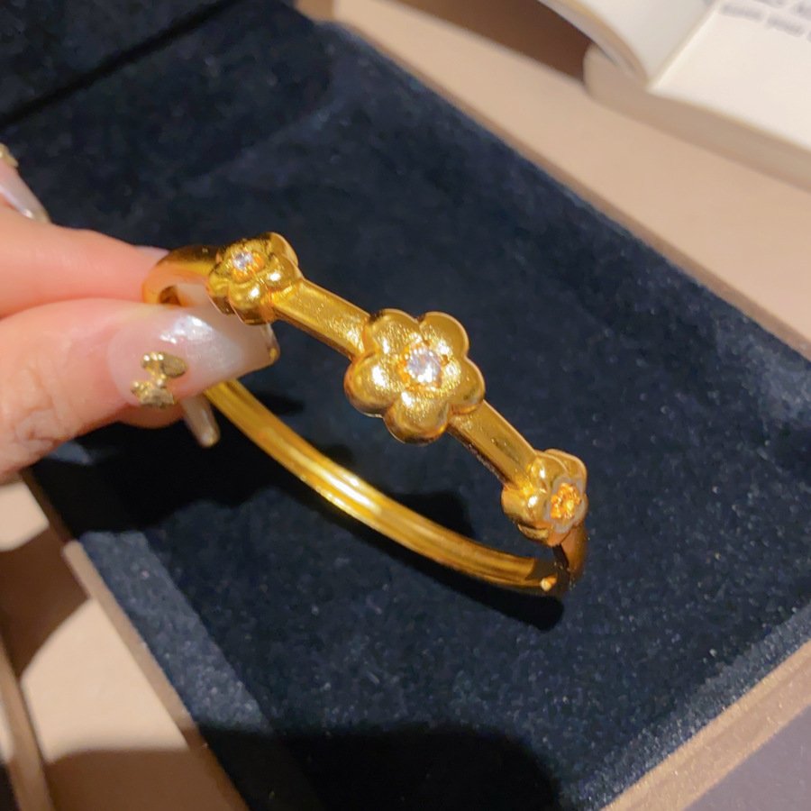 Celestial Aurum Blossom Bangle with heart clasp, artisan jewelry in blue.
