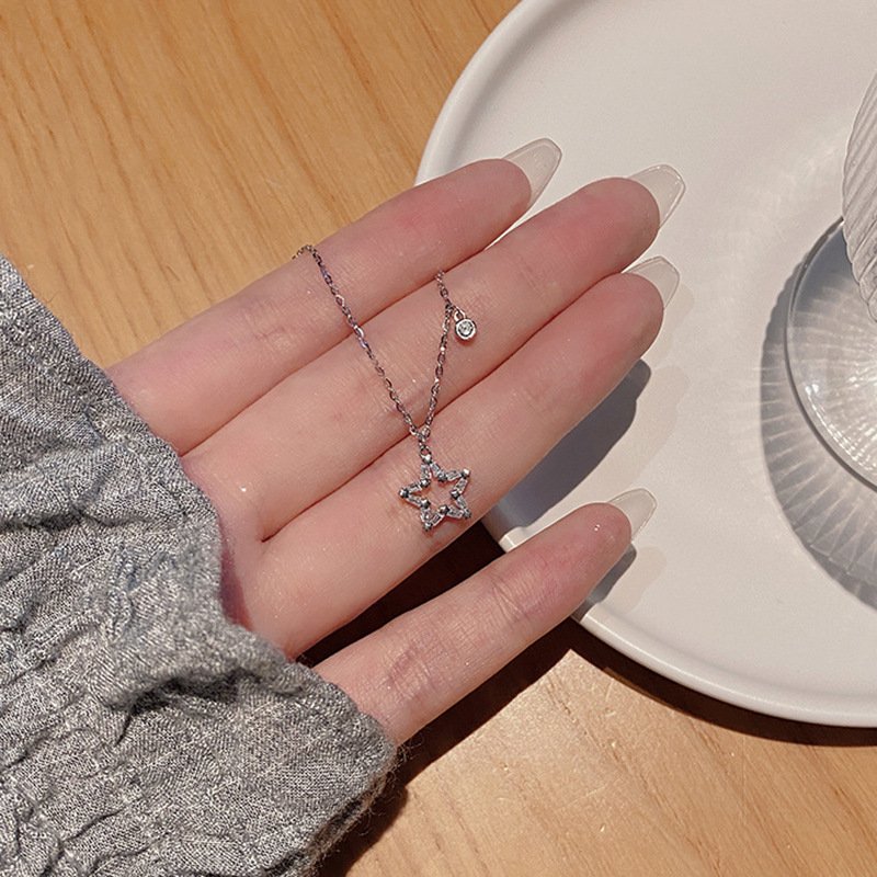 Lunar silver charm necklace with celestial metal pendant for balance and protection.