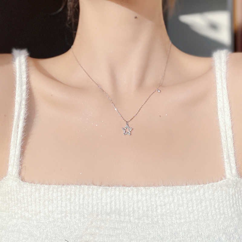 Lunar silver charm necklace with celestial design for balance and protection.