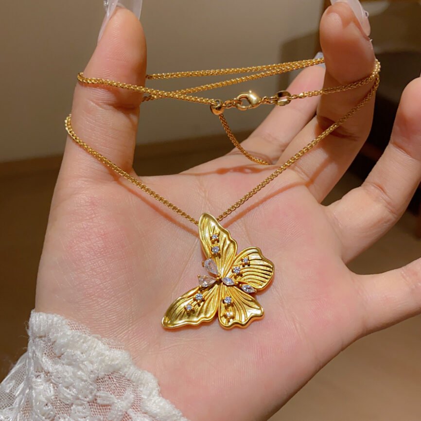 Golden Chrysalis Talisman necklace with metallic charm, symbolizing transformation and balance.
