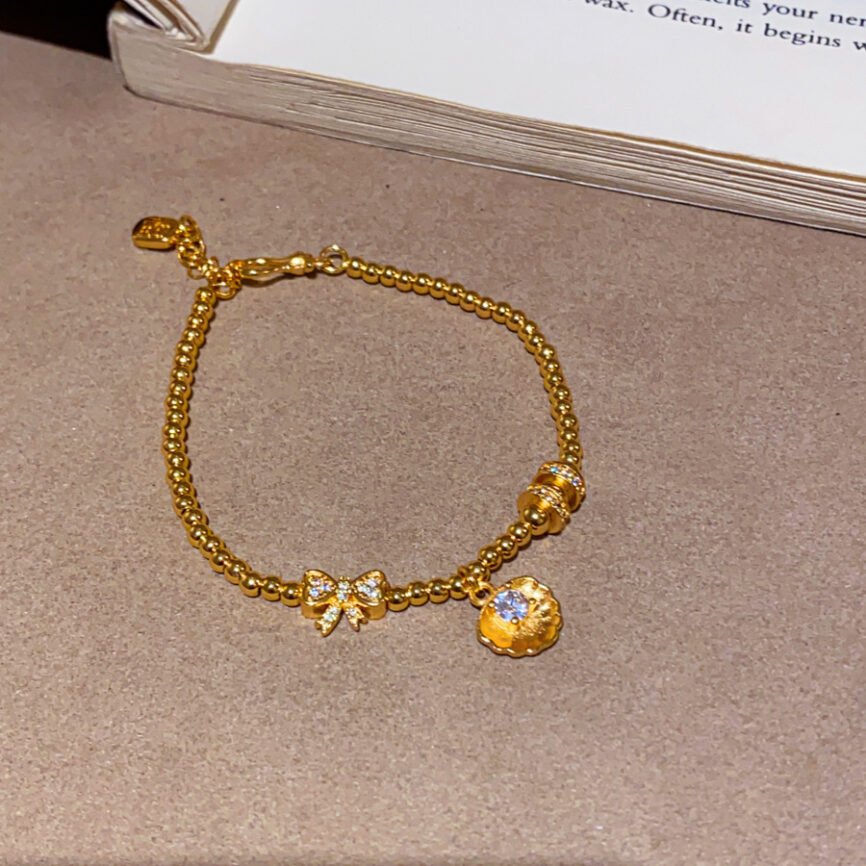 Blue Aurelian Pearl Purity Chain bangle bracelet with metallic charm.