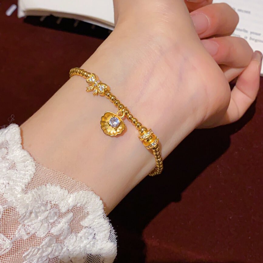 Aurelian Pearl Purity Chain bangle bracelet with elegant metal charm.