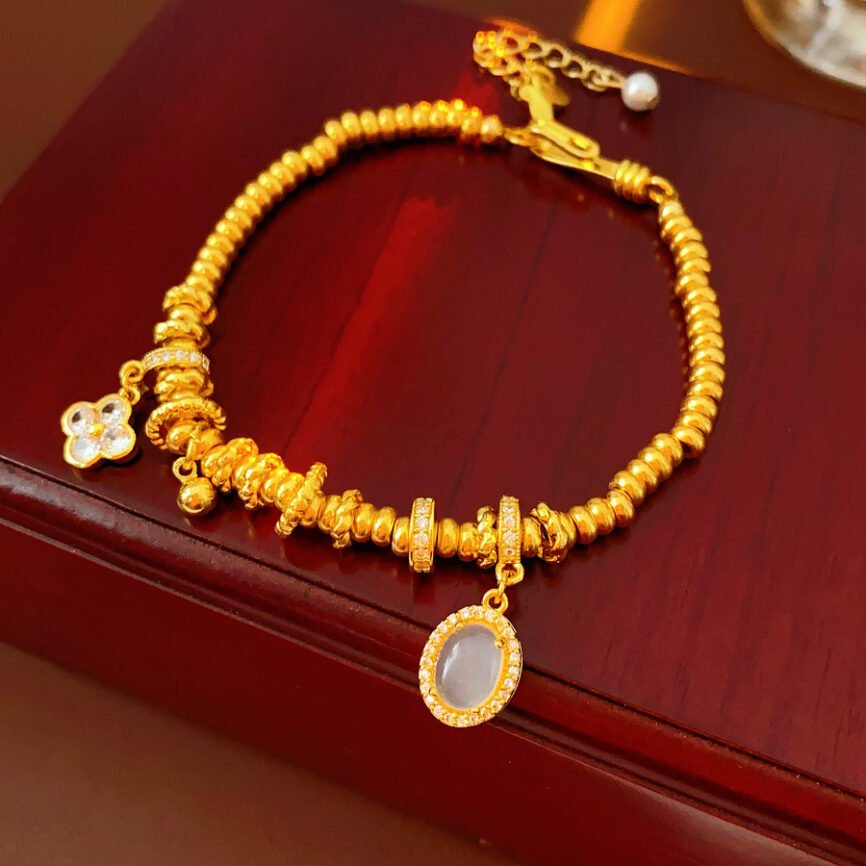 Golden Blossom Aura bangle bracelet with radiant metal charm for women.