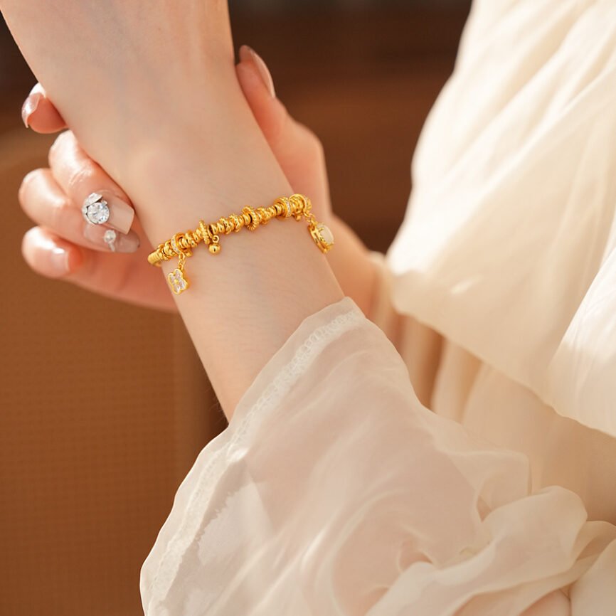 Golden Blossom Aura bangle bracelet for women with radiant metal charm.