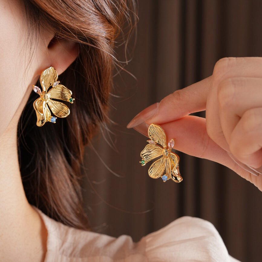 Golden Flow Blossom Drops earrings with radiant metal charm for harmonious balance.