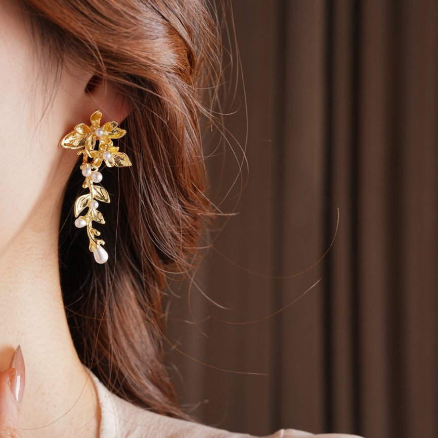 Lunar Pearl silver drop earrings with jade charm, blue variant close-up.