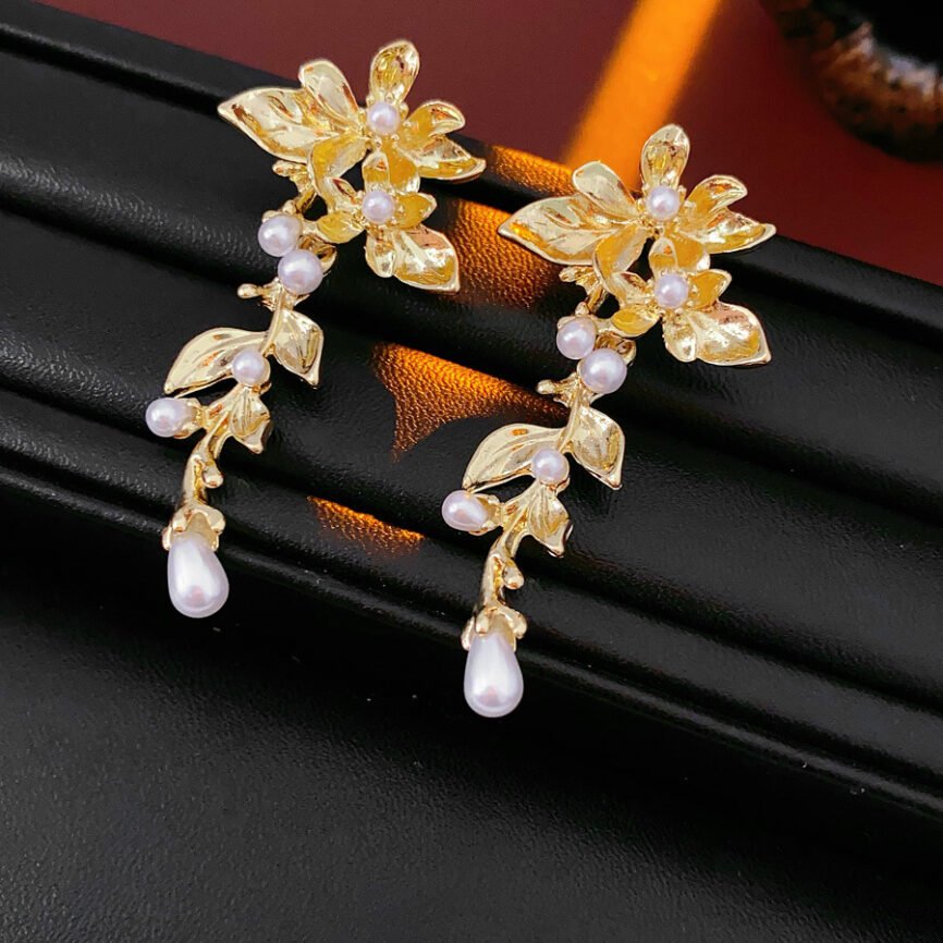 Silver drop earrings with pearl accents, balancing energy and harmony.