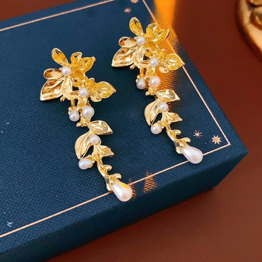 Silver jade drop earrings with radiant pendant details, artisan jewelry close-up.