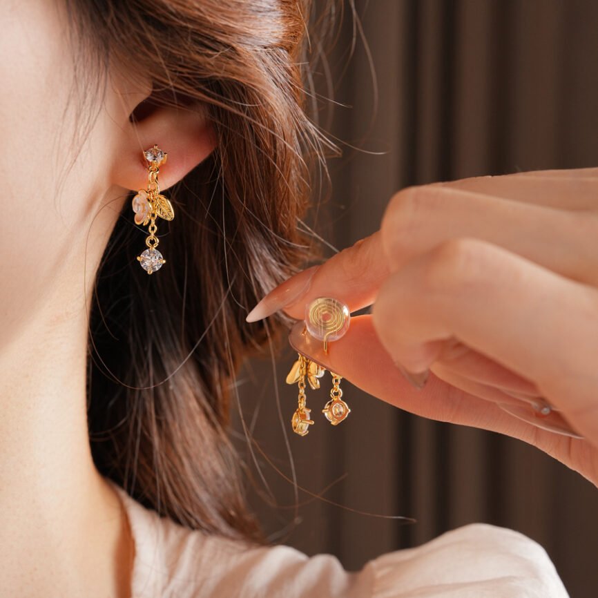 Blue jade earrings with gold accents and luminous pearl details.
