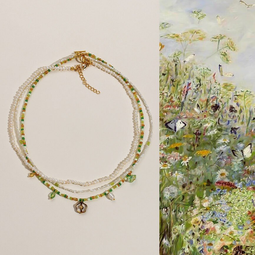 Emerald Breeze pearl strand necklace with flourishing wood charm for wealth and serenity.