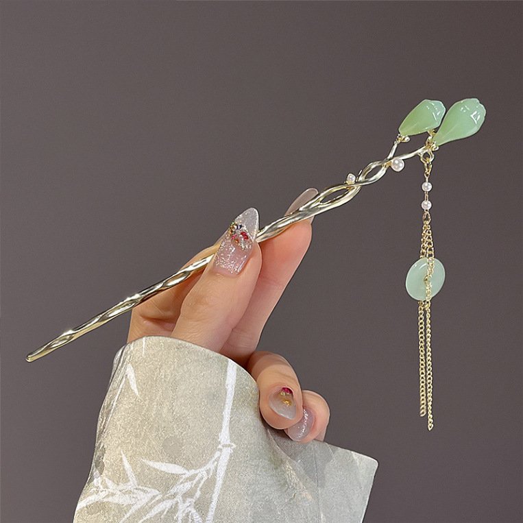 Blue Fiona Franchimon hairpin with elegant charm, close-up view.