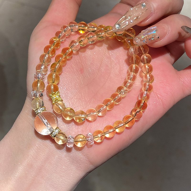 Golden Terra Fortune Beads bracelet with blue charm, gold bangle design.