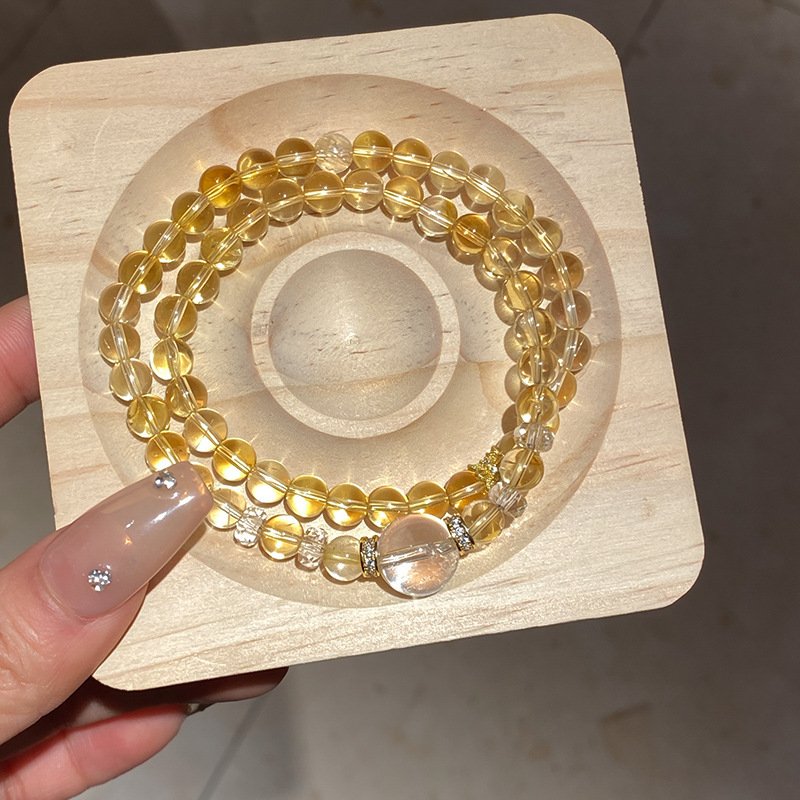 Golden Terra Fortune Beads bracelet with blue charm, a gold bangle bracelet for prosperity.