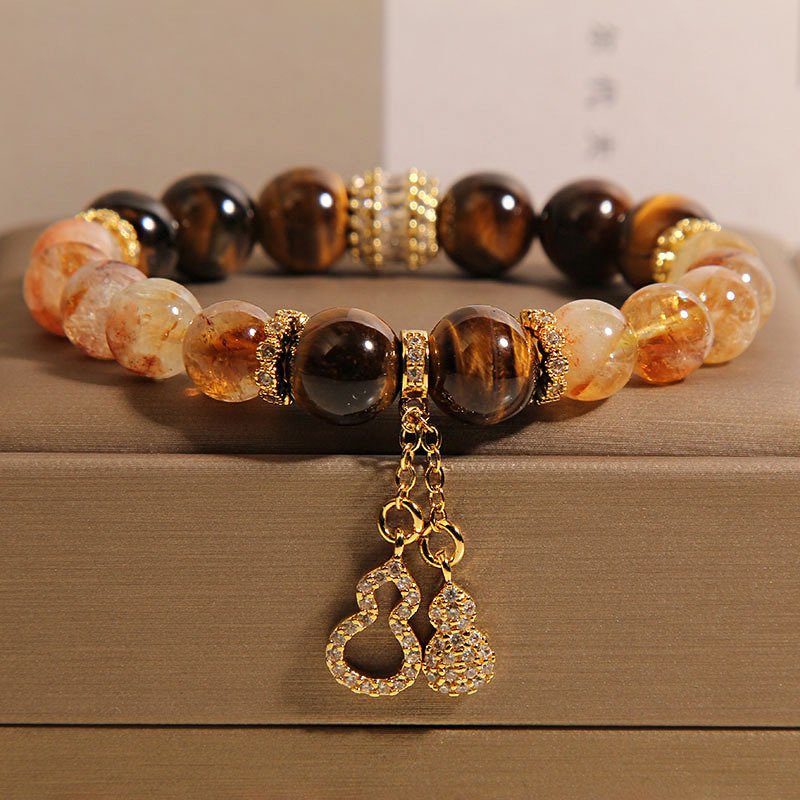 Blue Earthbound Harmony Bracelet with gold charms, inspired by ancient Chinese wisdom.