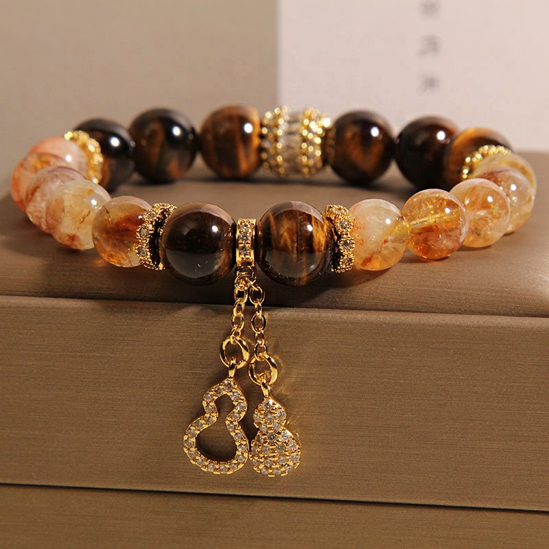 Blue Earthbound Harmony Bracelet with gold charms, inspired by ancient Chinese wisdom.