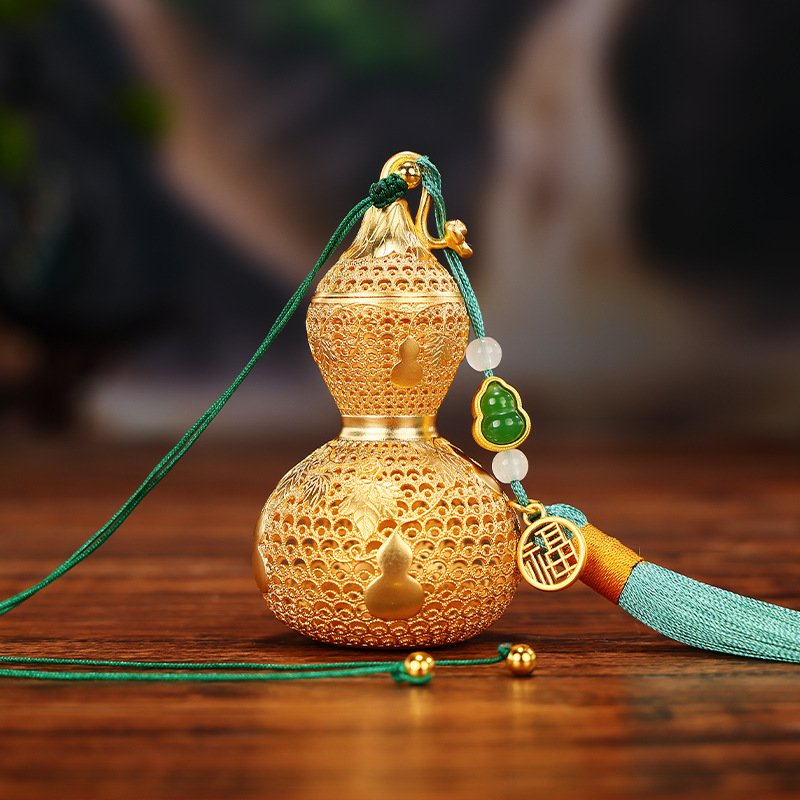 Blue jadeite pendant in the shape of a blessing gourd, grounding energy.