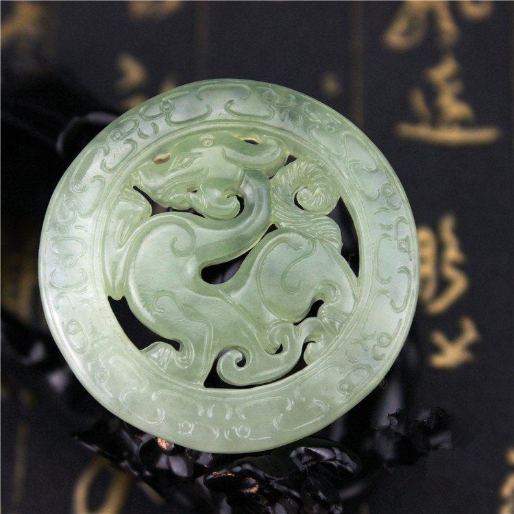 Blue twin dragon jade pendant with intricate carvings, balancing energy.