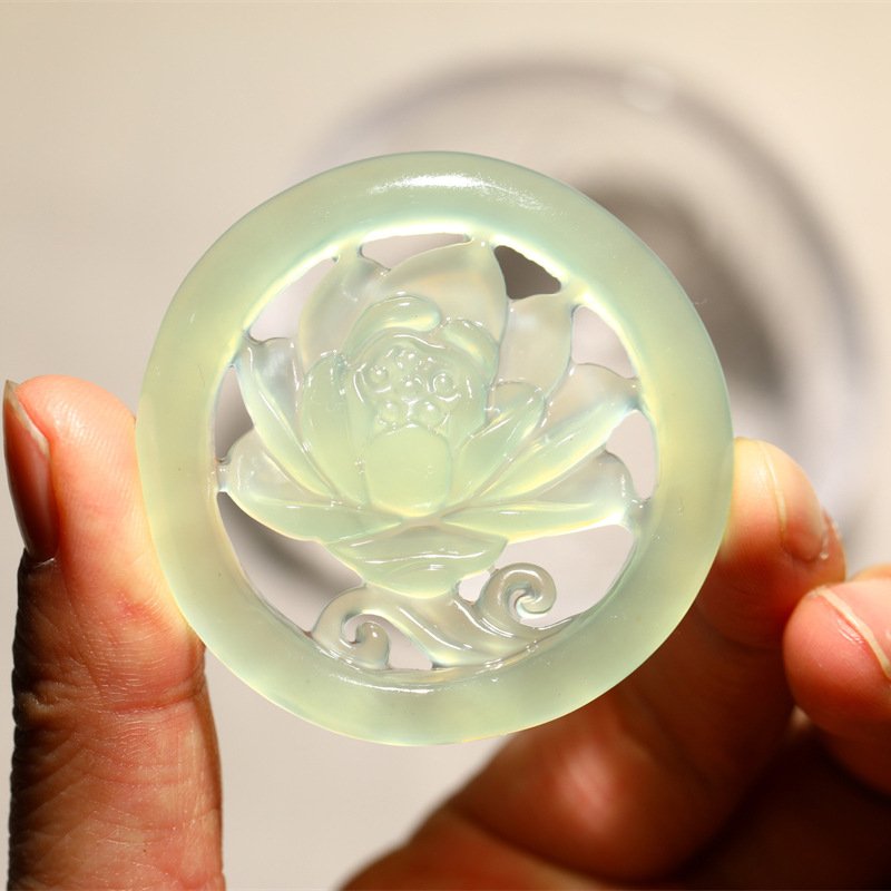 Blue jadeite pendant featuring an ethereal lotus charm for cosmic harmony.