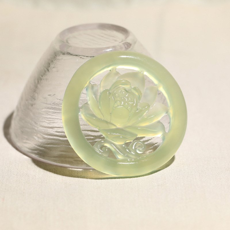 Blue jadeite pendant with lotus charm for cosmic harmony.
