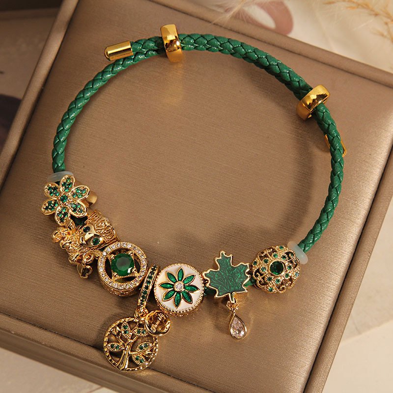 Close-up of Verdant Mystic Charm Bracelet with gold charms, artisan jewelry.