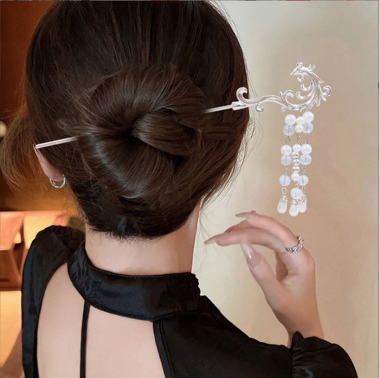 Blue Mistpeak Radiance hairpin with celestial charm detail.