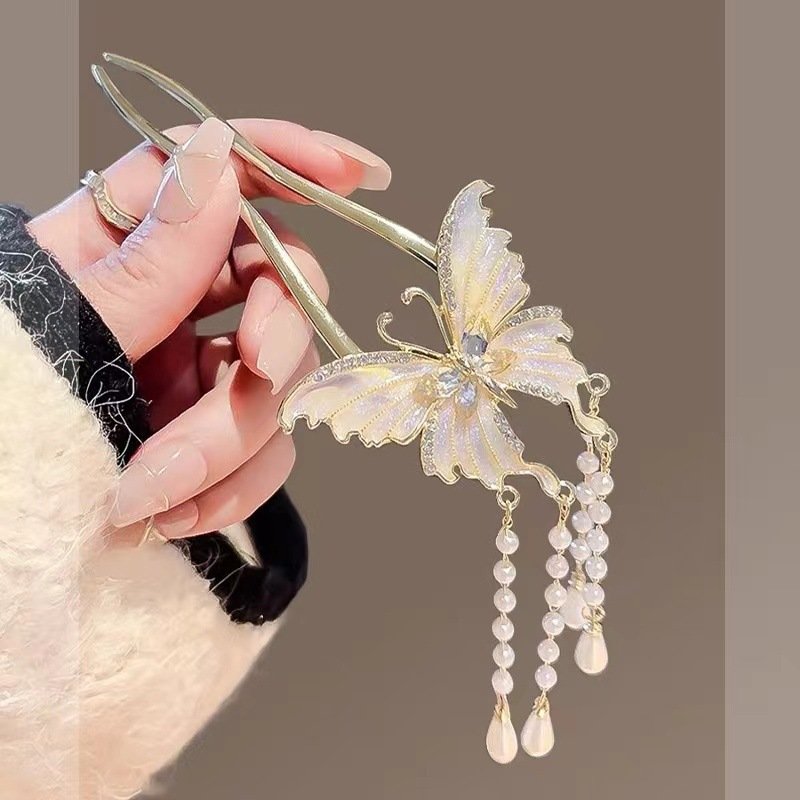 Blue ethereal butterfly cloud hairpin by Fiona Franchimon, close-up of celestial charm.