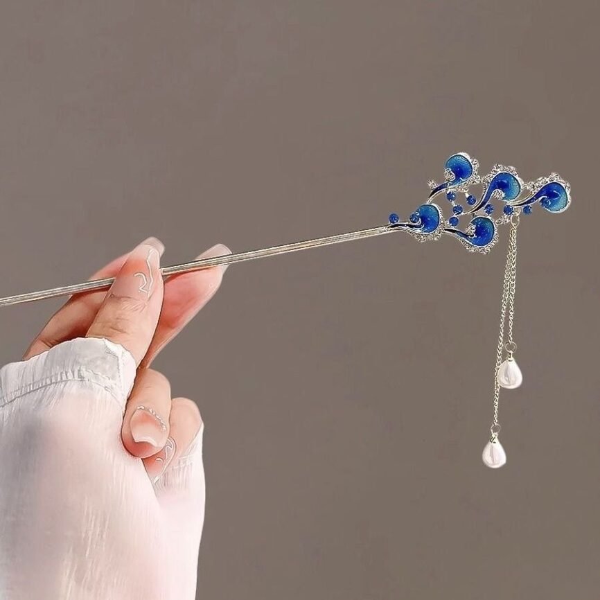 Blue Fiona Franchimon hairpin with celestial phoenix charm, close-up.