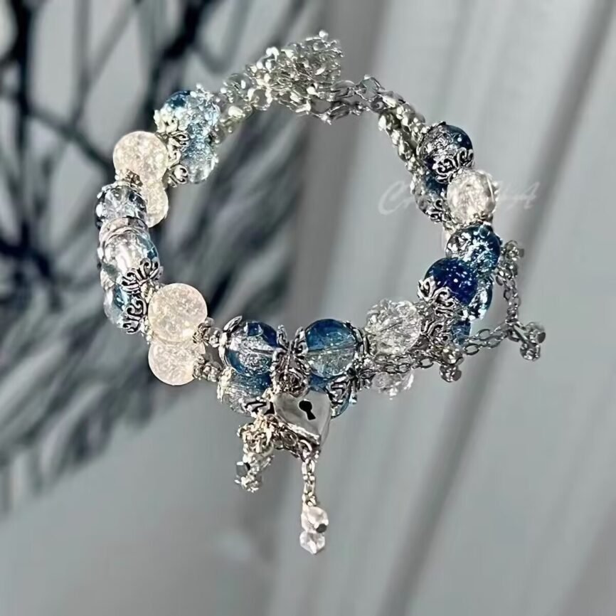 Blue celestial pearl bangle bracelet with radiant charm.