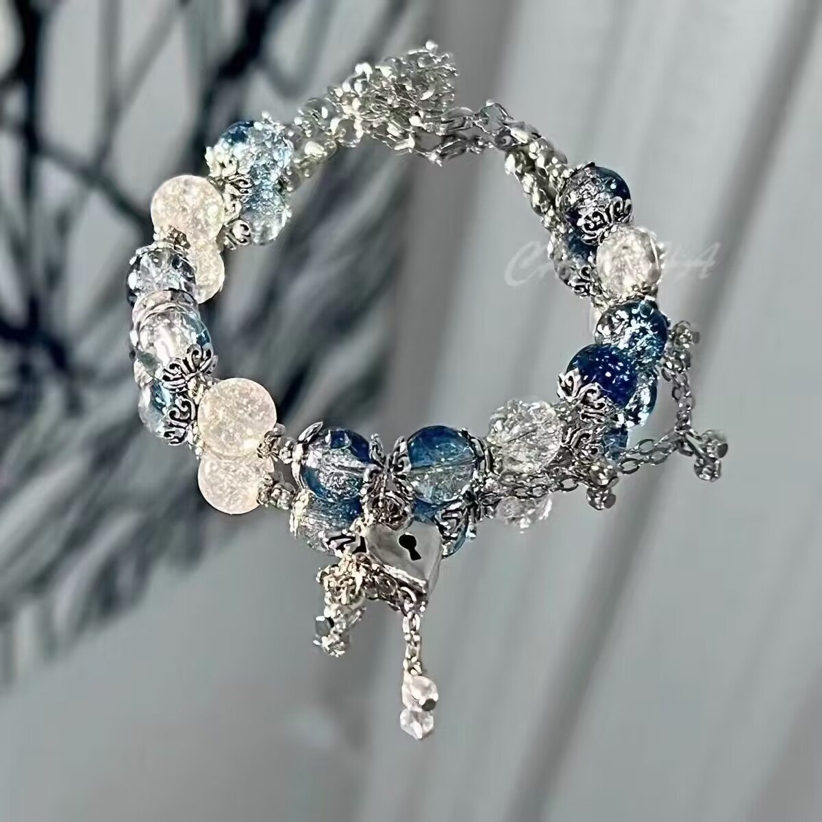 Blue celestial pearl bangle bracelet with radiant charm.